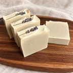 Lavender Meadow honey and beeswax soap bars with dried lavender on a wooden tray