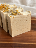 Close-up of The Herbalist soap showing its handmade texture and botanical top